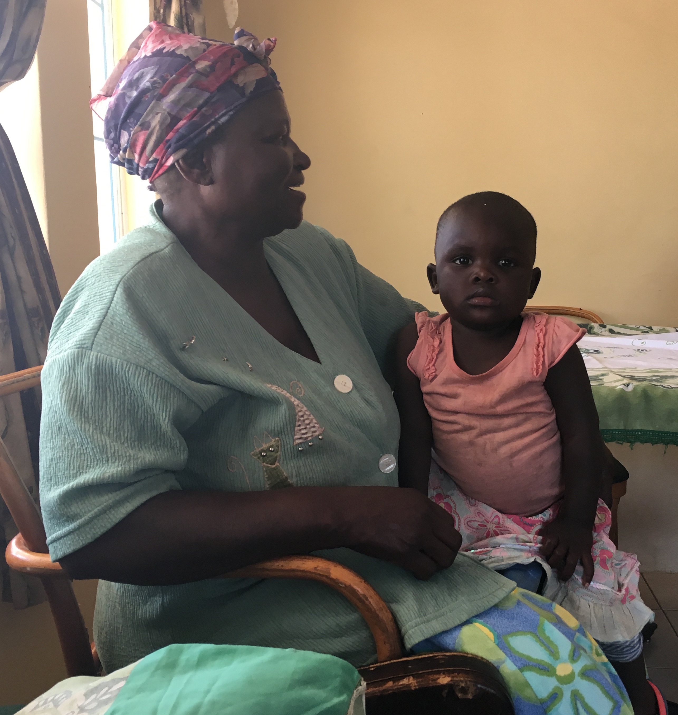 Lillian, another long serving house mother, 31 years, cuddles one of the children in her care