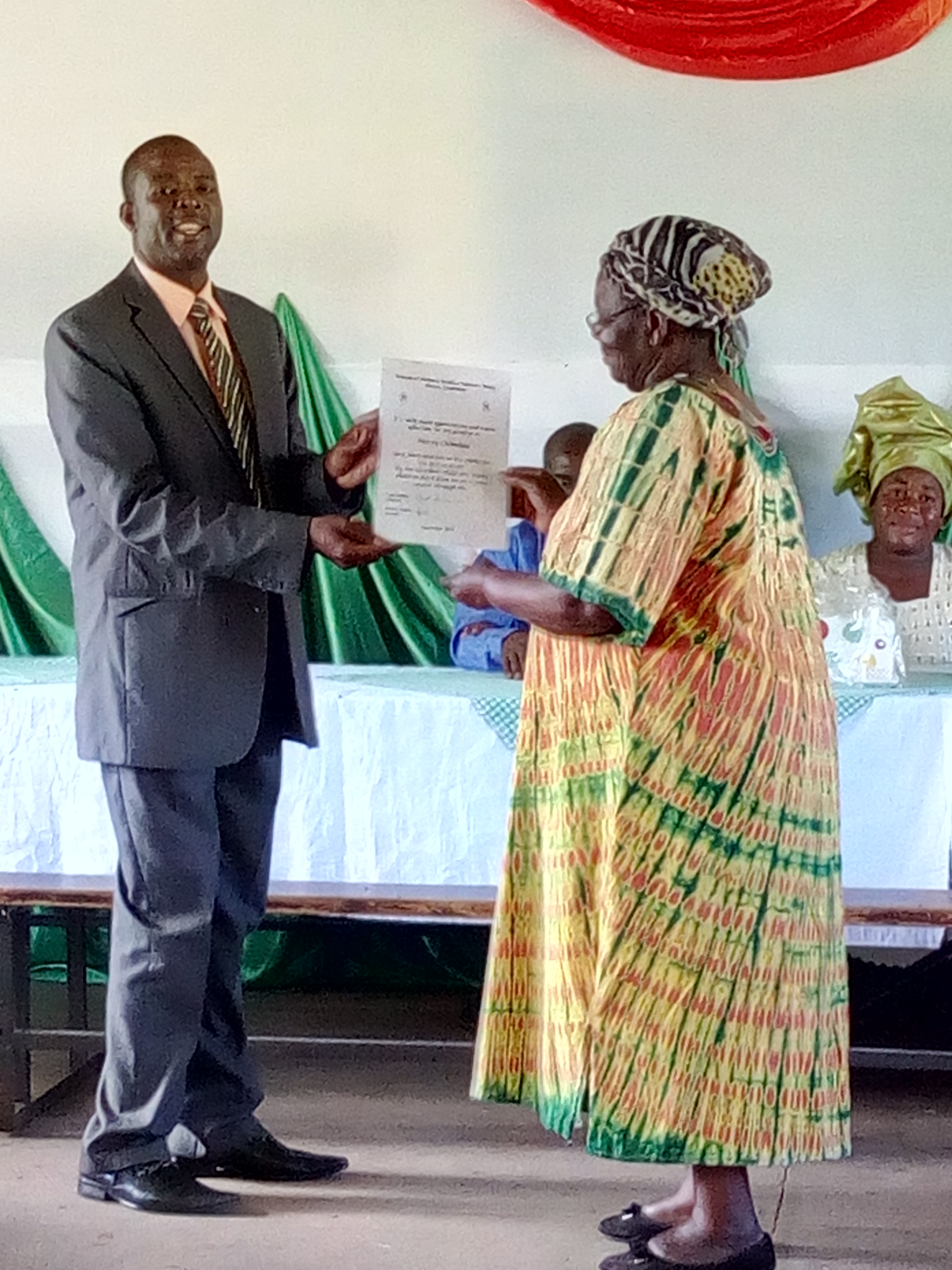 Mercy, the longest serving house mother at 32 years, retires. Here she receives a certificate of appreciation from the Friends of MRCH. Mercy cooked the main meal for visitors and staff  as well as the 10-12 children in her care