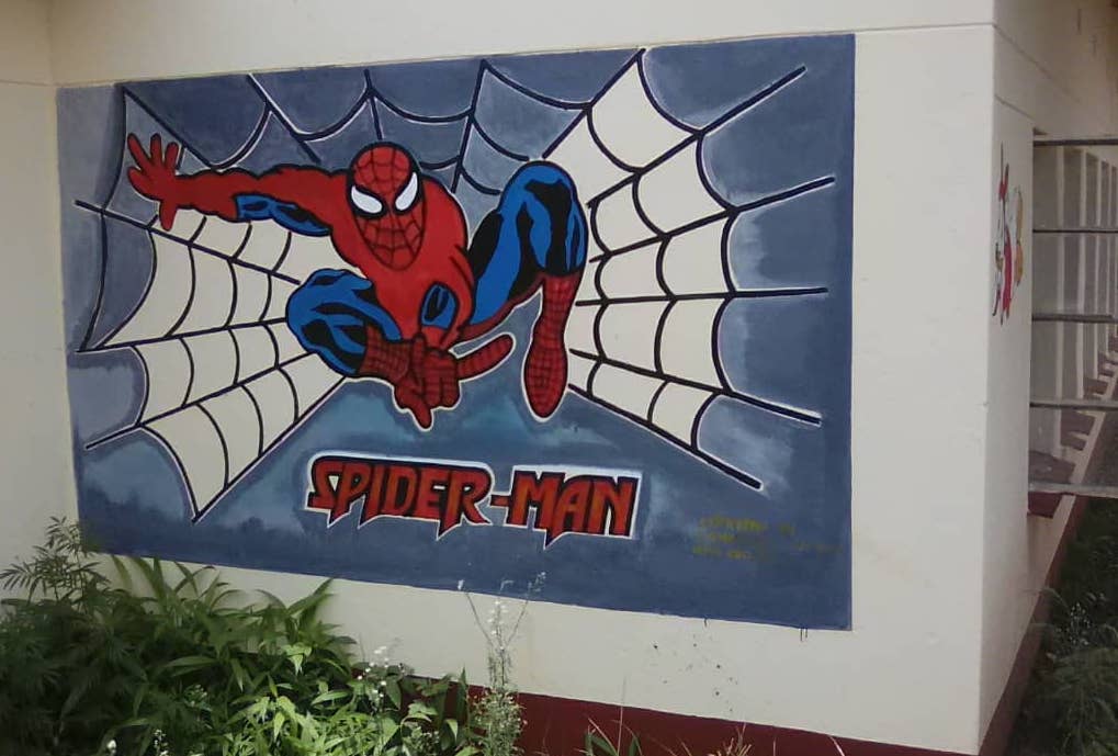 An outside wall covered with Spiderman